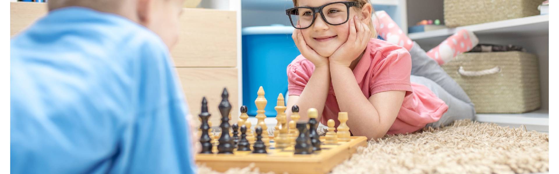 a-little-girl-and-a-boy-playing-with-games-and-puzzles-including-chess